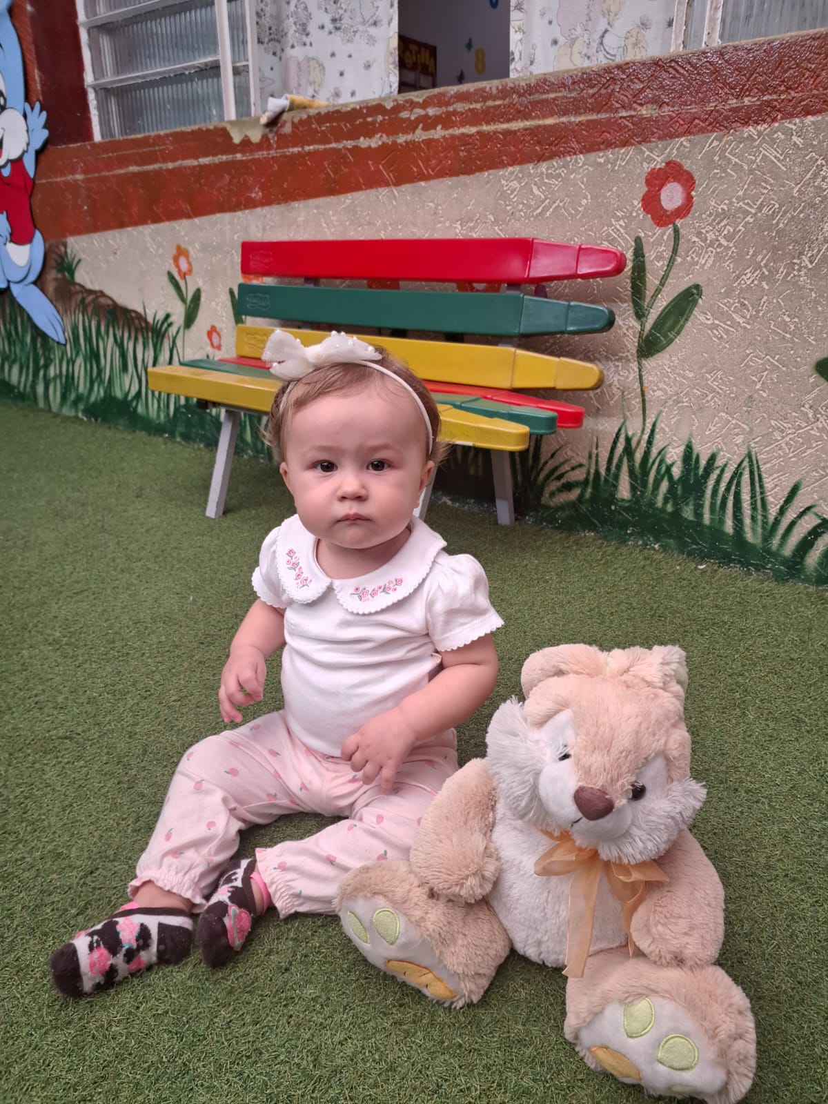 Bebê do berçário brincando com pelúcia na escola